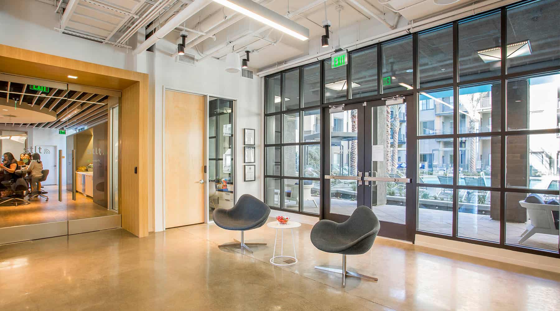 Open office space with glass doors and modern design.