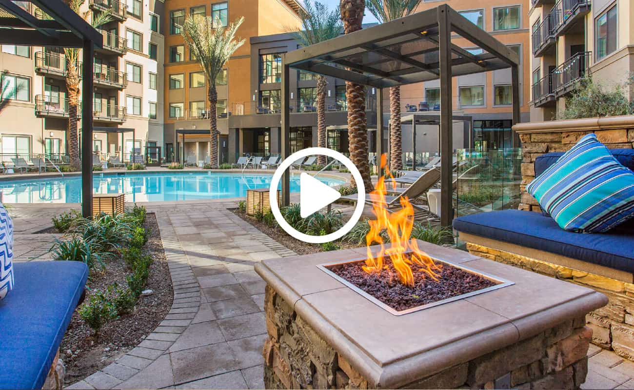 Screenshot of a video showing The Colony’s pool area with a firepit and outdoor seating.