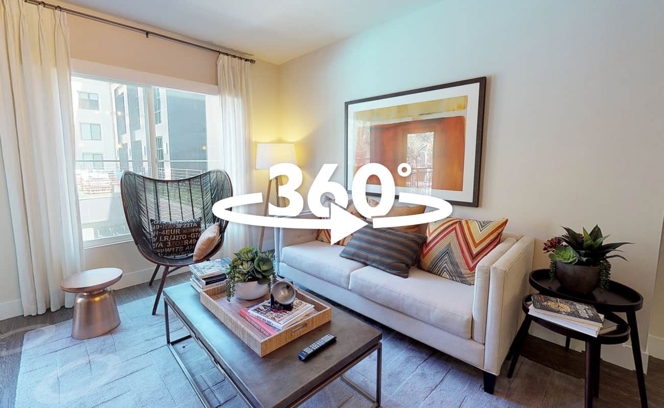 360-degree view of a two-bedroom, two-bathroom model apartment with a spacious kitchen and comfortable living area.
